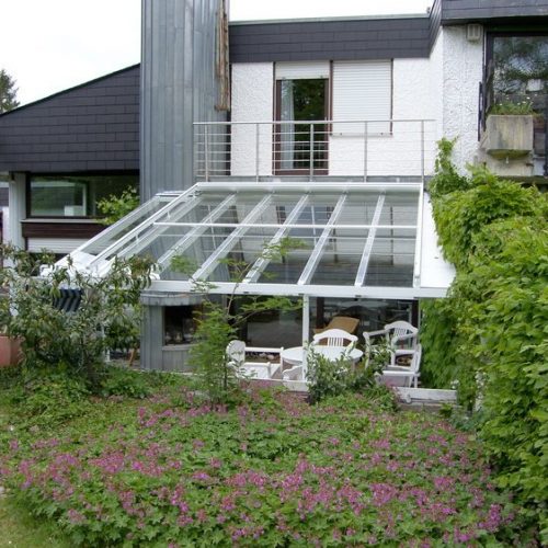 schräge Terrassenüberdachung mit großen Glaselementen