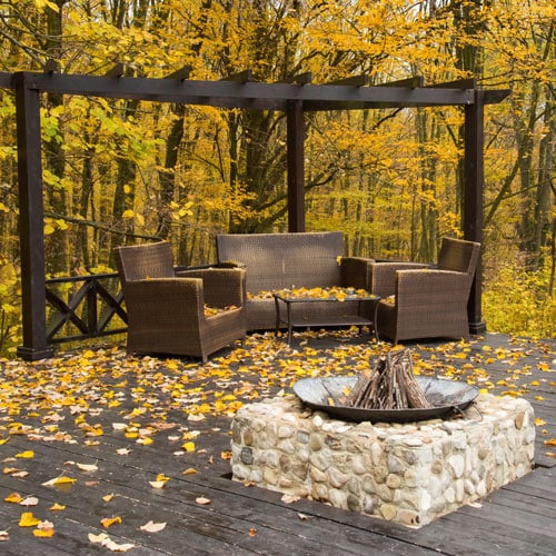 Cozy Autumn patio with chairs, hearth and firewoods.Exterior in
